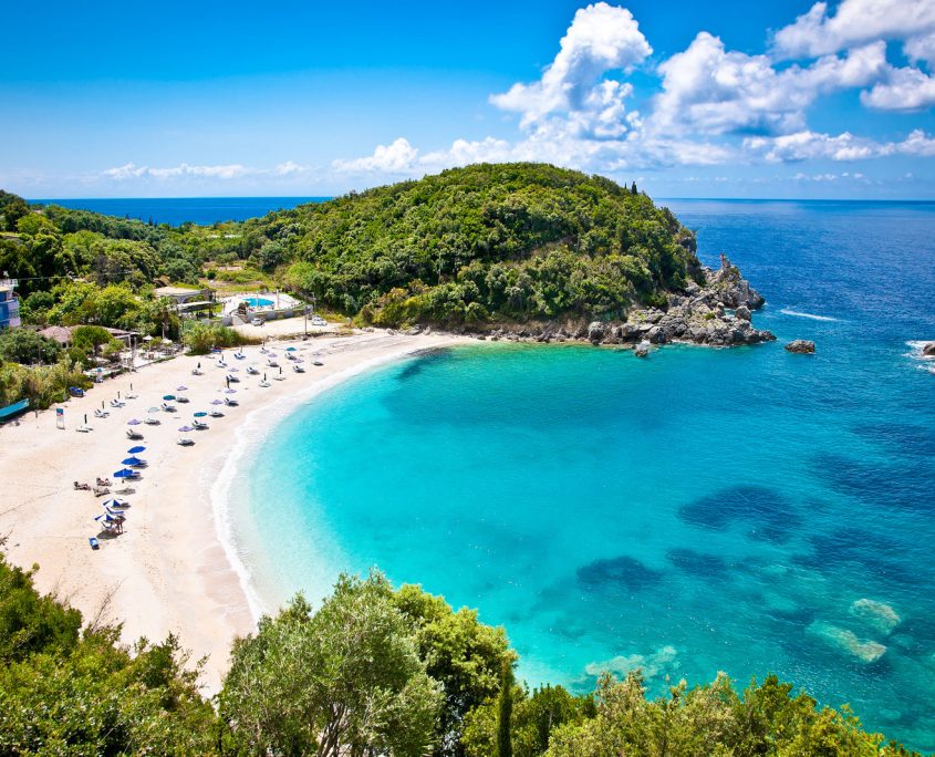 Asaya-Hills-Villas-Parga-Greece-sea-beach-nature-summer-holidays Panoramic shot of a beautiful gulf with crystal turquoise waters and a sand beach, surrounded by green hills at Parga, Greece.