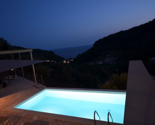 Asaya-Hills-Villas-Parga-Greece-private-villas-swimming-pool-balcony-night-holidays Night shot of lighted swimming pool and balcony of a private villa at Asaya Hills Villas, Parga, Greece.