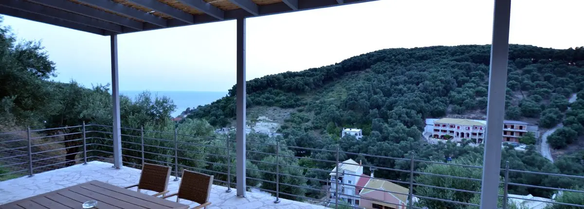 Balcony of a private villa overlooking the sea and green hills at Parga, Greece.