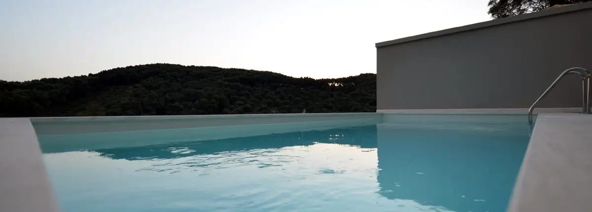 Close-up of a swimming pool at a private villa overlooking a green hill at Parga, Greece.