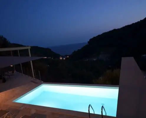 Night shot of lighted swimming pool and balcony of a private villa at Parga, Greece. 
