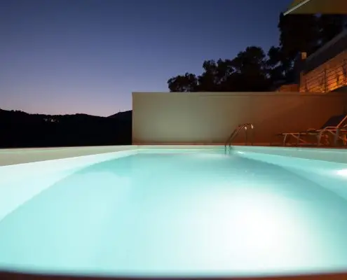 Close-up nightshot of a lighted swimming pool at the exterior of a private villa at Parga, Greece.