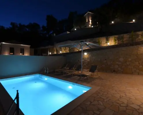 Night shot of a lighted swimming pool at the exterior space of a private villa at Parga, Greece.